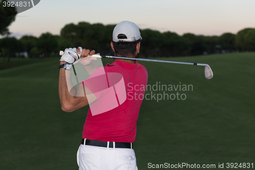 Image of golfer hitting a sand bunker shot on sunset