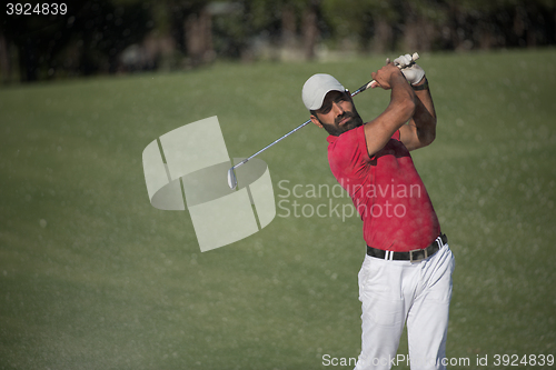 Image of golfer hitting a sand bunker shot