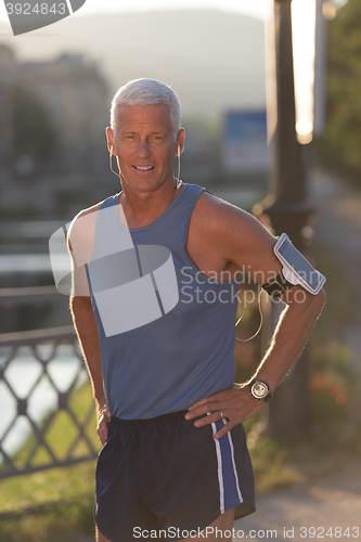 Image of portrait of handsome senior jogging man