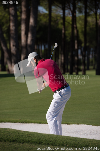 Image of golfer hitting a sand bunker shot