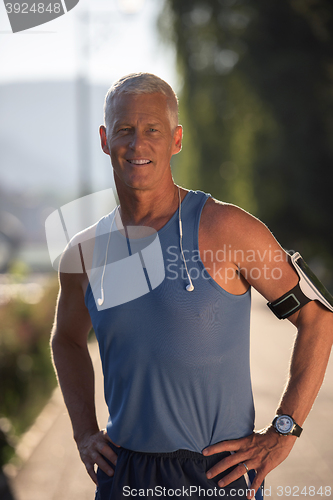 Image of portrait of handsome senior jogging man