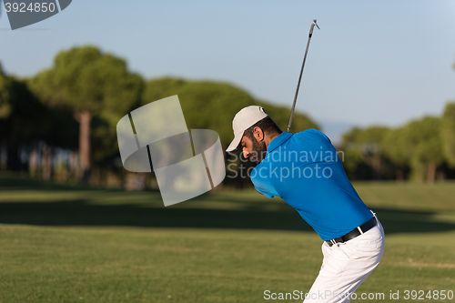 Image of pro golfer hitting a sand bunker shot