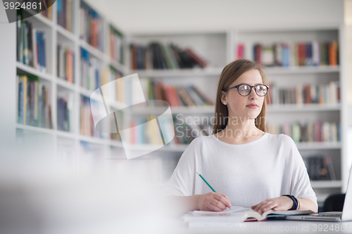 Image of female student study in school library