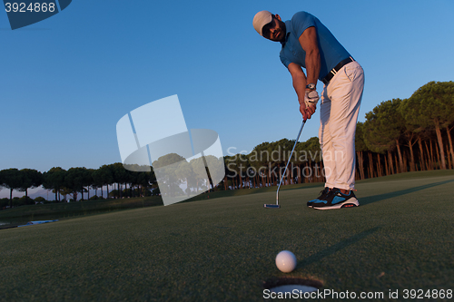 Image of golfer  hitting shot at golf course