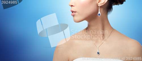 Image of close up of woman with earring and pendant