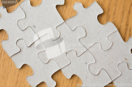 Image of close up of puzzle pieces on wooden surface