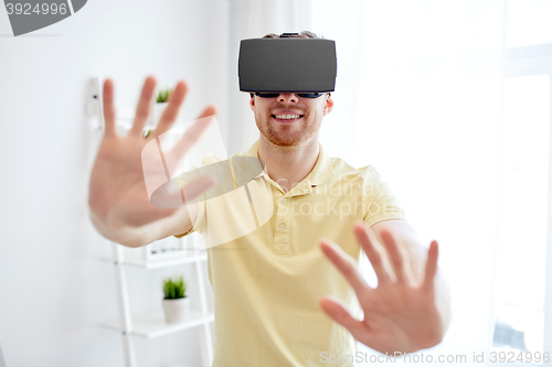 Image of young man in virtual reality headset or 3d glasses