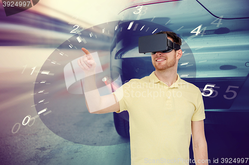 Image of man in virtual reality headset and car racing game