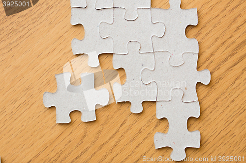 Image of close up of puzzle pieces on wooden surface