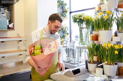 Image of florist man or seller at flower shop cashbox