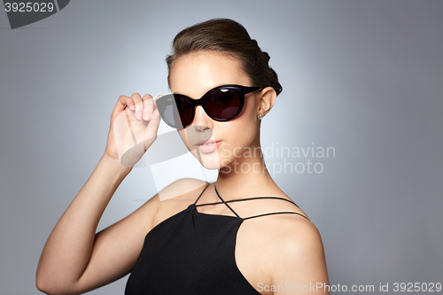 Image of beautiful young woman in elegant black sunglasses