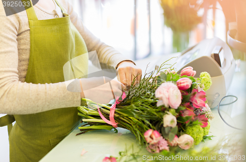 Image of close up of woman making bunch at flower shop