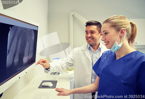 Image of dentists with x-ray on monitor at dental clinic