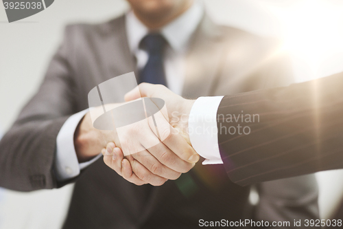 Image of two businessmen shaking hands in office