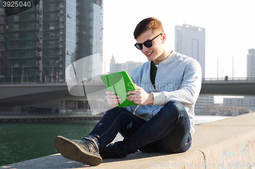 Image of happy young man with tablet pc over city bridge