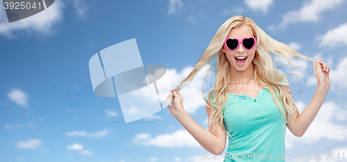 Image of happy young blonde woman or teenager in sunglasses