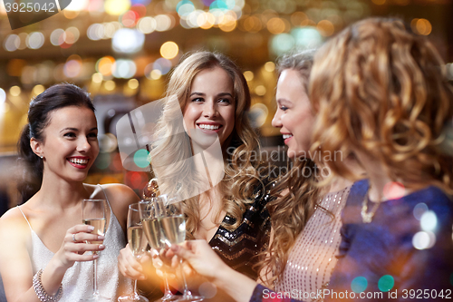 Image of happy women with champagne glasses at night club