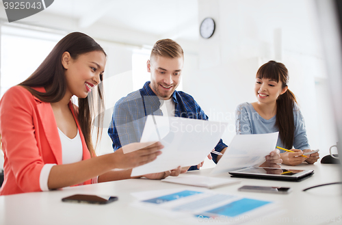 Image of happy creative team or students working at office