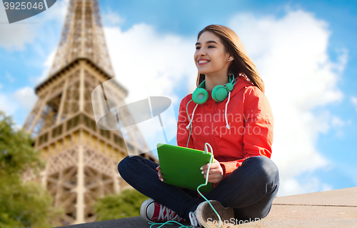 Image of happy young woman with tablet pc and headphones