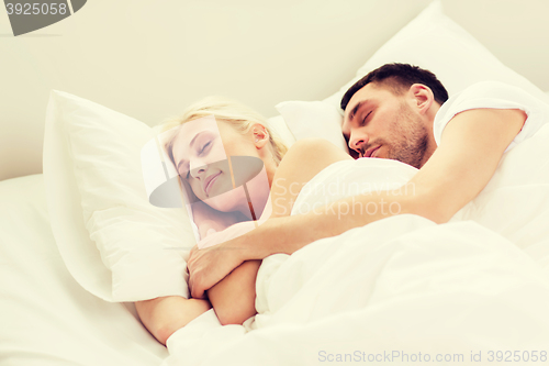 Image of happy couple sleeping in bed at home