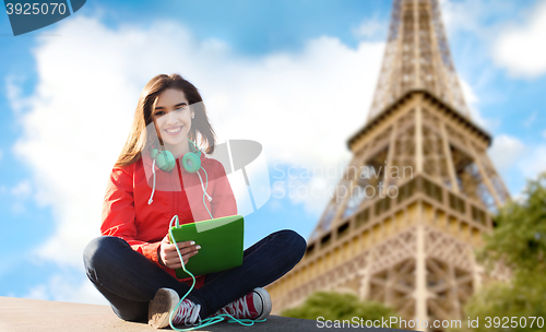 Image of happy young woman with tablet pc and headphones