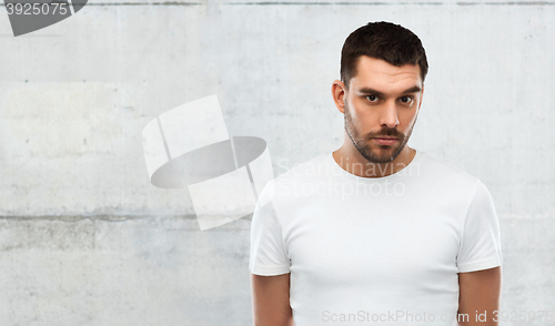 Image of young man portrait over gray wall background