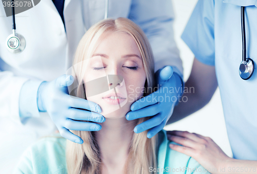 Image of plastic surgeon or doctor with patient