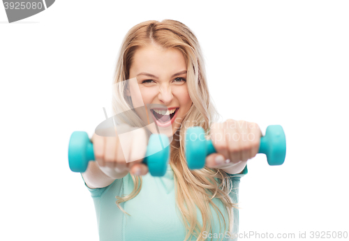 Image of smiling beautiful young sporty woman with dumbbell