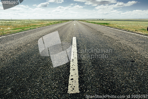 Image of asphalt road with a marking leaving afar