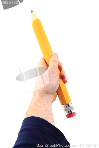 Image of big pencil in human hand