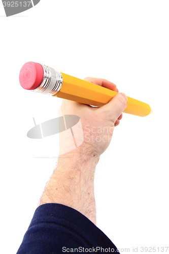 Image of big pencil in human hand