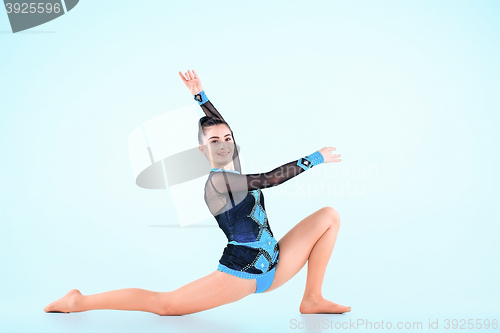 Image of The girl doing gymnastics dance on a blue background