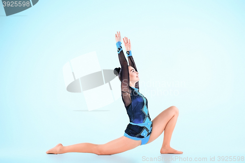 Image of The girl doing gymnastics dance on a blue background