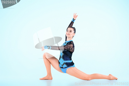 Image of The girl doing gymnastics dance on a blue background