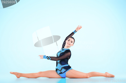 Image of The girl doing gymnastics dance on a blue background