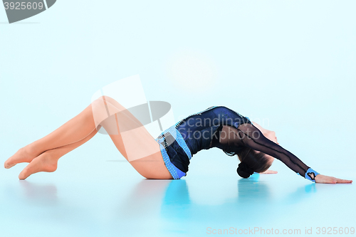 Image of The girl doing gymnastics dance on a blue background