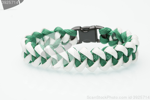 Image of green braided bracelet on white background