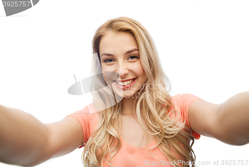 Image of happy smiling young woman taking selfie