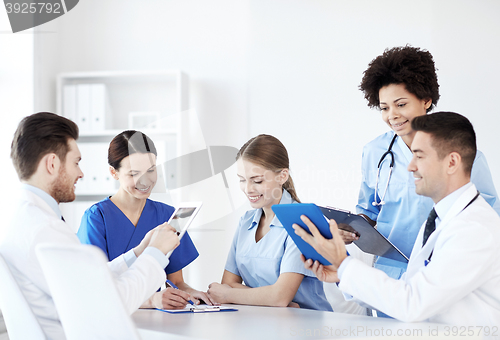 Image of group of happy doctors meeting at hospital office