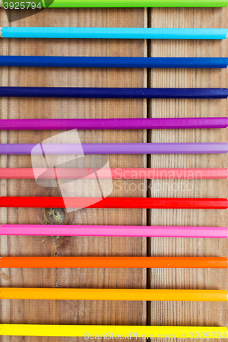 Image of close up of crayons or color pencils on wood