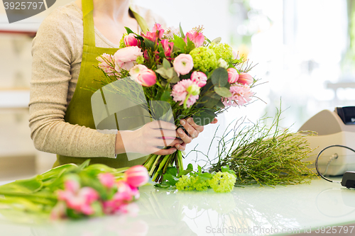 Image of close up of woman making bunch at flower shop