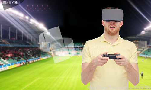 Image of man in virtual reality headset over football field