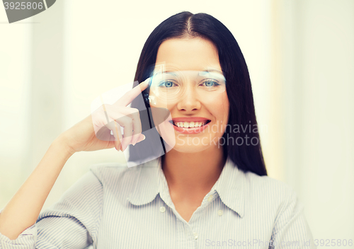 Image of smiling woman pointing to futuristic glasses