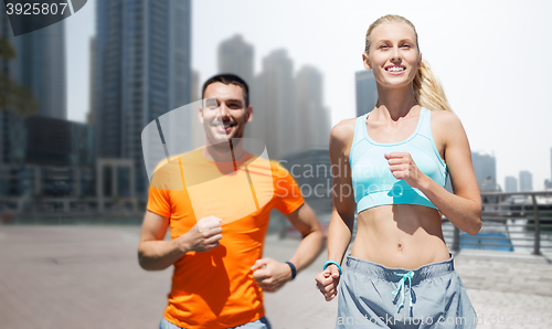 Image of couple running over dubai city street background