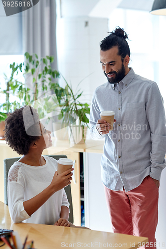 Image of happy man and woman drinking coffee in office