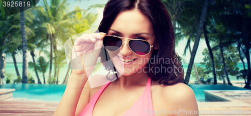 Image of happy woman in sunglasses and swimsuit