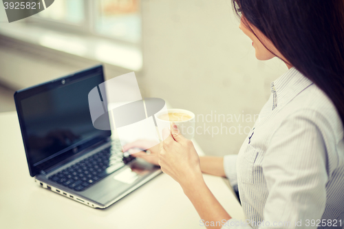 Image of close up of woman with laptop drinking coffee