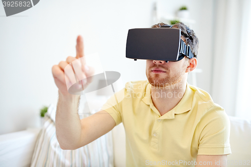 Image of young man in virtual reality headset or 3d glasses