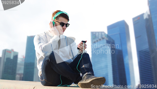 Image of happy young man in headphones with smartphone