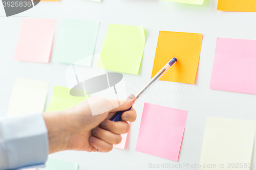 Image of close up of hand pointing to sticker on flip chart